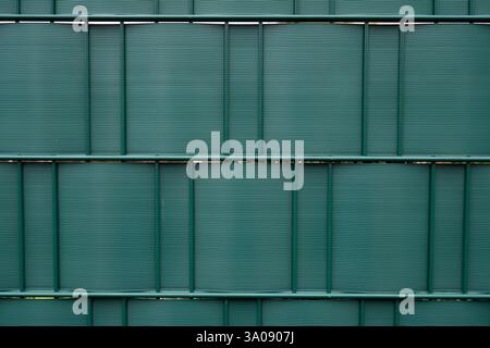 Metal fence with green plastic material, Background Photo Stock Photo