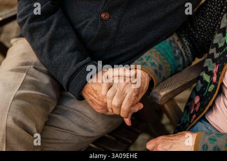 High angle midsection of senior couple holding each other hands Stock Photo