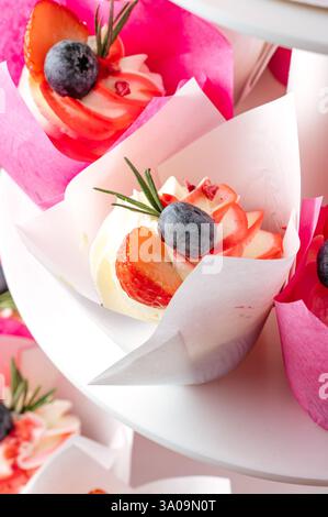 cupcakes with berries on a stand Stock Photo