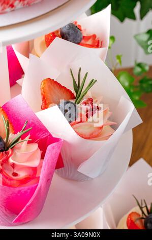 cupcakes with berries on a stand Stock Photo
