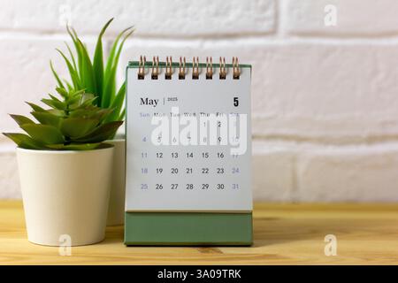Hello, May. The planning calendar for May 2025 is on your desktop Stock Photo