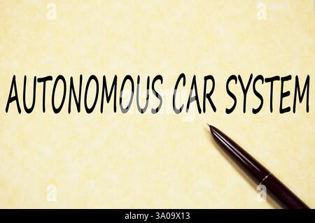 Handwritten phrase AUTONOMOUS CAR SYSTEM on vintage parchment paper Stock Photo