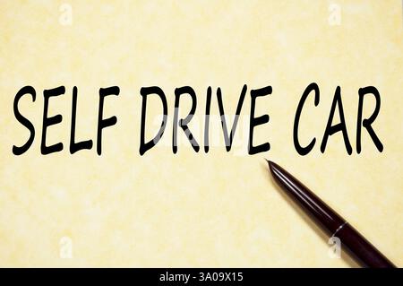 Handwritten text SELF DRIVE CAR on old parchment paper with dark pen Stock Photo