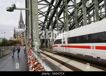ICE train crossing river Rhine with Cologne Cathedral in background Stock Photo