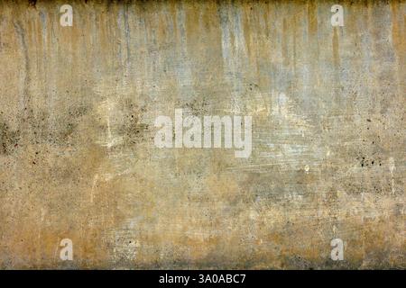 rough concrete wall with yellow streaks and stains Stock Photo