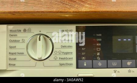 A view of the control panel of a modern washing machine. The operating panel of a washing machine. The concept of housework. Home washing concept. Stock Photo
