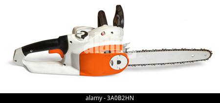 new, orange and white  electric chainsaw resting on a white background Stock Photo