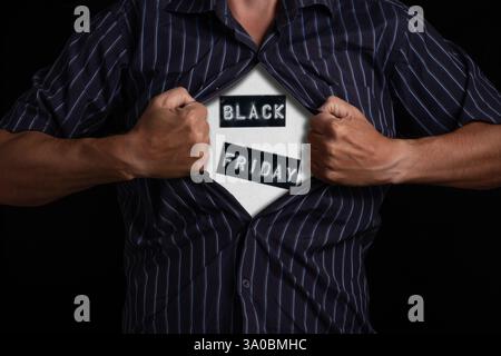 Businessman opening his shirt to show his black friday shirt Stock Photo