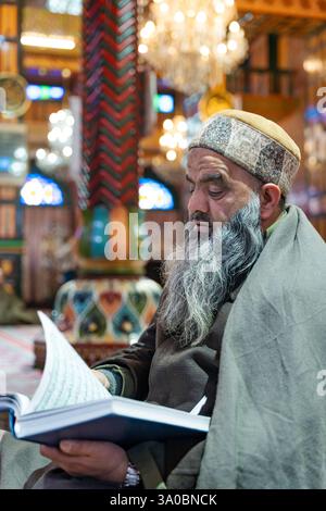 A Kashmiri Muslim man recites the Quran at the Shah-i-Hamdaan shrine ...