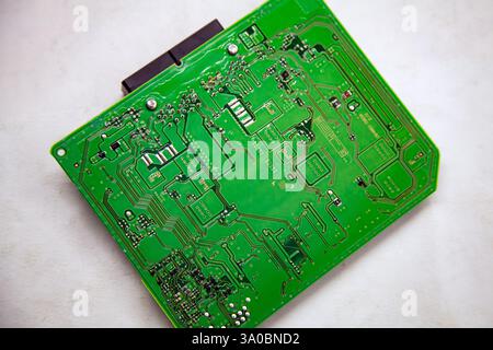 Background and texture of a printed circuit board with microchips and chips from a car safety module Stock Photo