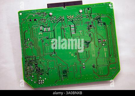 Background and texture of a printed circuit board with microchips and chips from a car safety module Stock Photo