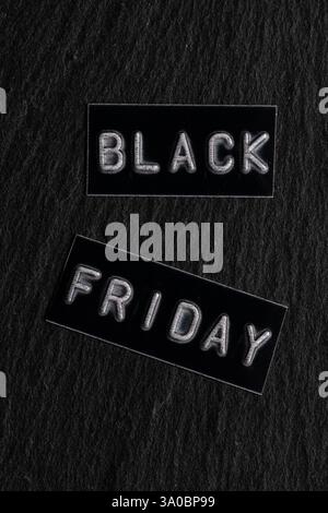 Black Friday text on black label on dark stone background. Top view Stock Photo