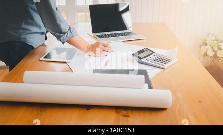 An architect or engineer writing on blueprint, architectural concept. Stock Photo
