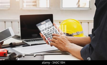 The engineering team is working on their project together. Stock Photo