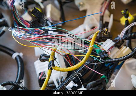 Wires, connectors, modules, and connections from a new car wiring harness to replace the old wiring in a vehicle Stock Photo