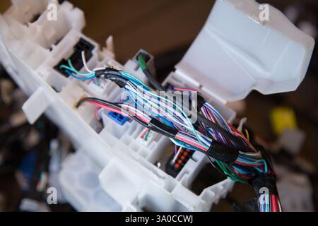 Wires, connectors, modules, and connections from a new car wiring harness to replace the old wiring in a vehicle Stock Photo