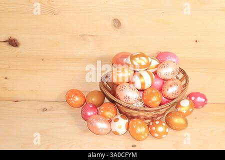 Decorated golden Easter eggs on a wooden background. greeting card, Happy Easter concept, background. Creative painting eggs at home, idea of simple d Stock Photo