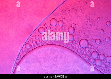 Pink circles on oily surface Stock Photo