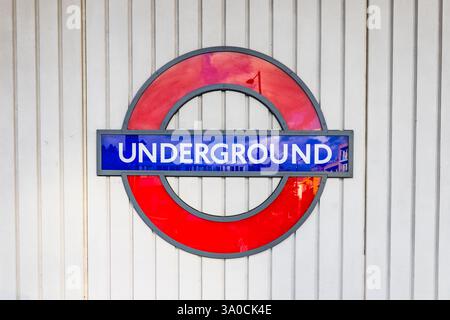The iconic tube station sign of a red circle with a blue stripe, known ...