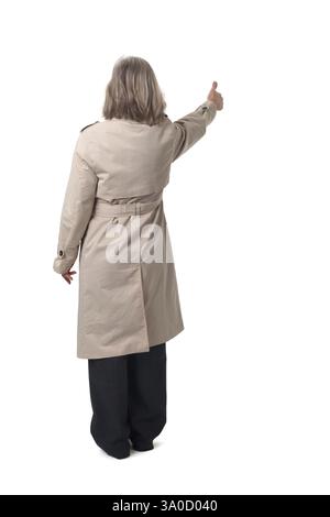 back view of a woman with thumbs up on white background Stock Photo