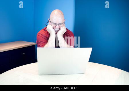 Elderly person confused by technology and has been scammed on line Stock Photo