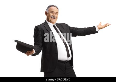 Mature man in black suit and tie dancing and holding a hat isolated on white background Stock Photo
