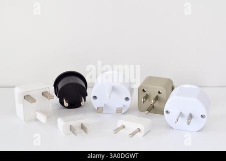 A group of travel power adapters on white background Stock Photo