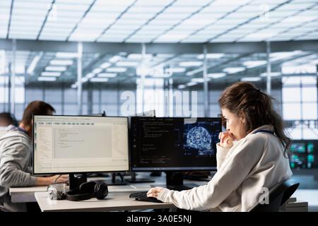 Computer scientist doing data center automation using AI and machine learning tools. IT expert integrating artificial intelligence driven automation in server hub operations Stock Photo