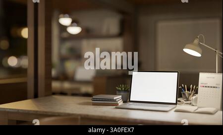 A white screen laptop and books on wooden table under the lamp light. Study or working at night. 3d rendering, 3d illustration. Stock Photo