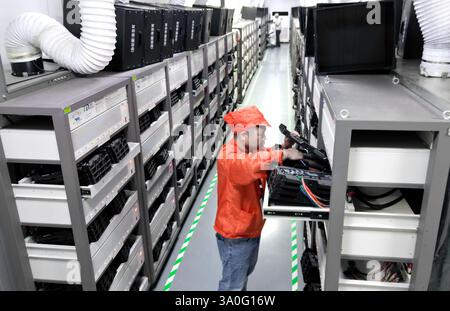 HAIAN, CHINA - MARCH 4, 2025 - A worker produces consumer lithium battery products in a workshop in Hai'an, Jiangsu province, China, March 4, 2025. Stock Photo