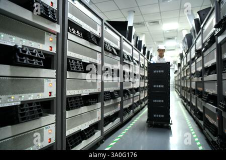 HAIAN, CHINA - MARCH 4, 2025 - A worker produces consumer lithium battery products in a workshop in Hai'an, Jiangsu province, China, March 4, 2025. Stock Photo