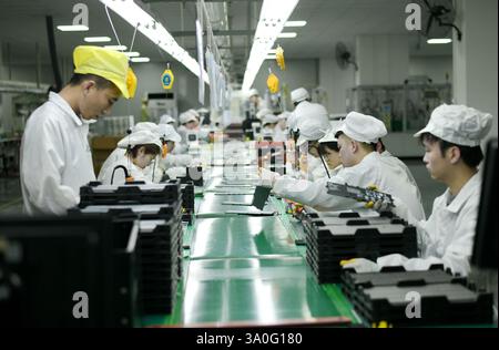 HAIAN, CHINA - MARCH 4, 2025 - A worker produces consumer lithium battery products in a workshop in Hai'an, Jiangsu province, China, March 4, 2025. Stock Photo