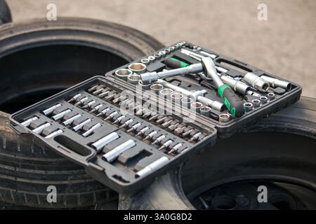 Set of tools on the car wheel. Close-up shot. Stock Photo
