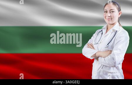 Female Doctor On Bulgarian Flag. Doctor With Crossed Arms On Bulgarian Flag. Bulgaria Health And Care Concept Stock Photo