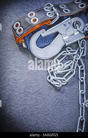 Building safety belt with metal chain on black background construction concept Stock Photo