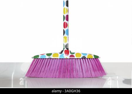 Coloured broom Stock Photo