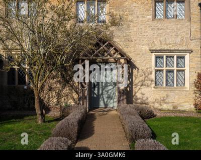 Stone built cottage bedroom, part of the accommodation at the Falcon Hotel, Castle Ashby village, Northamptonshire, UK Stock Photo
