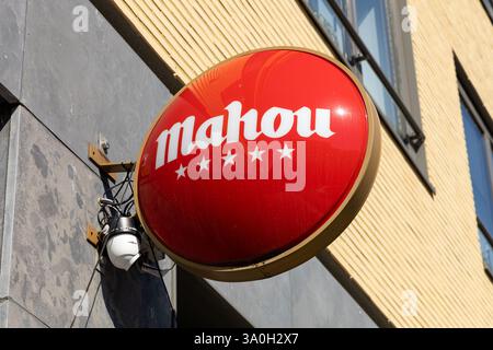 Mahou logo sign at a bar. Mahou San Miguel is a Spanish beer brewing company. Stock Photo