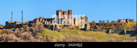 Dover, United Kingdom - March 25, 2016: Panoramic view to Dover Castle and St Mary church  with copy space in sky. Castle was founded in the 11th cent Stock Photo