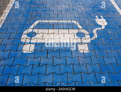 electric car parking spot painted blue with white car and electric car, . High quality photo Stock Photo