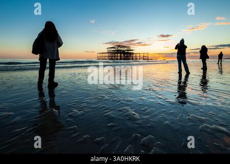 Sunset at West Pier ruins on Brighton beach, East Sussex, England. Stock Photo
