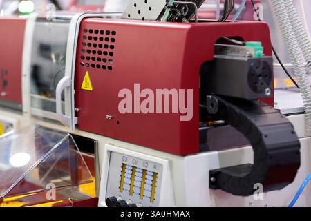 Small automatic plastic injection molding machine closeup. Selective focus. Stock Photo
