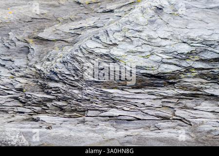 Close up horizontal photo of slate rock with tiny spots of lichens. Stock Photo