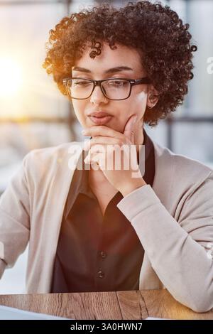 Young mixed race businesswoman smiling to camera Stock Photo