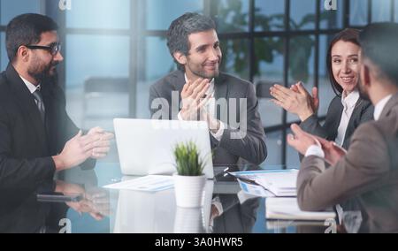 Smiling businesspeople having a discussion while collaborating on a new project in an office. Stock Photo