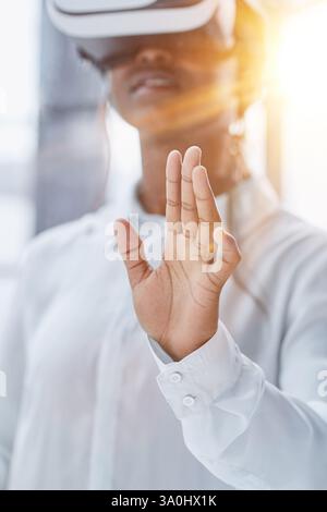 Businesswoman using vr glasses to view educational material and financial documents Stock Photo
