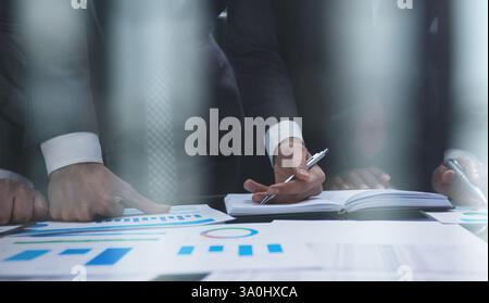 business colleagues look at the graph on the table from above Stock Photo