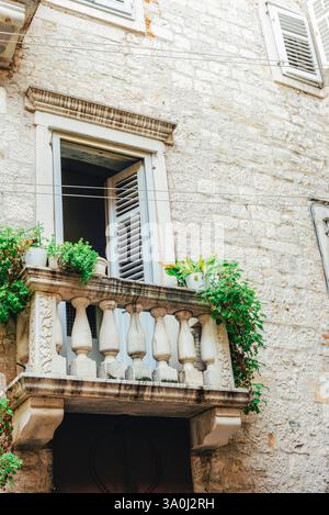 Old stone building with a small balcony and green plants. Split, Croatia. Stock Photo