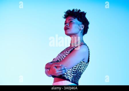 Curly haired African American woman showcases her trendy style with elegance and poise. Stock Photo