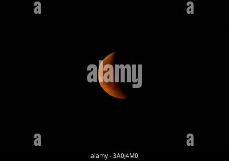 Red waning crescent phase of the moon. Stock Photo